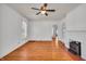 Bright, airy living room featuring hardwood floors, a fireplace, and a ceiling fan at 136 W 43Rd St, Indianapolis, IN 46208