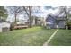 Spacious backyard with a dining set and garden space, perfect for outdoor entertaining and relaxation at 1542 Maple Ave, Noblesville, IN 46060