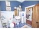 Bathroom featuring blue walls, classic white tile, and a pedestal sink at 1542 Maple Ave, Noblesville, IN 46060
