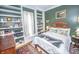Comfortable bedroom with built-in shelving, large window, and a cozy bed with decorative pillows at 1542 Maple Ave, Noblesville, IN 46060