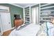 Charming bedroom featuring custom built-in shelving, a window seat, and an eye-catching accent wall at 1542 Maple Ave, Noblesville, IN 46060