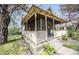 Inviting home showing a quaint, covered porch with detailed woodwork and a cozy chair at 1542 Maple Ave, Noblesville, IN 46060
