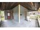 Detailed view of the covered front porch, showcasing a cozy chair, woodwork, and exterior door at 1542 Maple Ave, Noblesville, IN 46060