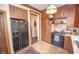 Traditional kitchen featuring wood cabinets, tile flooring, and modern appliances at 1542 Maple Ave, Noblesville, IN 46060