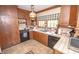 Charming kitchen with wood cabinets, tiled countertops, and functional appliances at 1542 Maple Ave, Noblesville, IN 46060