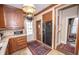 Cozy kitchen with wood cabinetry, black appliances, and a charming vintage aesthetic at 1542 Maple Ave, Noblesville, IN 46060