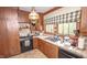 Well-equipped kitchen with wood cabinets, tile countertops, and an over-mount sink at 1542 Maple Ave, Noblesville, IN 46060