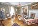 Inviting living room featuring hardwood floors, a brick fireplace, and ornate vintage details and decorations at 1542 Maple Ave, Noblesville, IN 46060