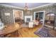Elegant living room showcasing detailed wallpaper, fireplace, and hardwood floors, exuding classic charm at 1542 Maple Ave, Noblesville, IN 46060