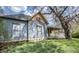 Side view of the house, highlighting its architecture and well-kept lawn with mature trees at 1542 Maple Ave, Noblesville, IN 46060