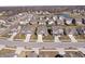 Aerial view of a residential neighborhood with a mix of home styles and a small pond at 16566 Branham Dr, Fishers, IN 46040