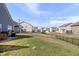 Spacious backyard with a black metal fence and view of neighboring homes at 16566 Branham Dr, Fishers, IN 46040