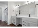 Elegant bathroom featuring dual sinks, a vanity area, and a glass-enclosed shower at 16566 Branham Dr, Fishers, IN 46040