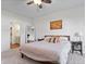Bedroom featuring neutral walls and carpet, a ceiling fan, and warm decorative accents at 16566 Branham Dr, Fishers, IN 46040