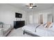 Bedroom with light walls, a ceiling fan, neutral bedding, and dark wood furniture at 16566 Branham Dr, Fishers, IN 46040