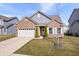 Charming single-Gathering home featuring a brick facade, attached garage and well maintained front yard at 16566 Branham Dr, Fishers, IN 46040