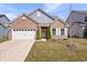 Charming single-Gathering home featuring a brick facade, attached garage and well maintained front yard at 16566 Branham Dr, Fishers, IN 46040