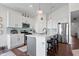 Modern kitchen featuring white cabinetry, stainless steel appliances, and a stylish breakfast bar at 16566 Branham Dr, Fishers, IN 46040