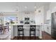 Modern white kitchen featuring an island with barstool seating and stainless steel appliances at 16566 Branham Dr, Fishers, IN 46040