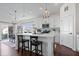 Bright kitchen with an island, pendant lighting, and stainless steel appliances adjacent to the dining area at 16566 Branham Dr, Fishers, IN 46040