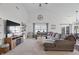 Bright living room with vaulted ceilings, plush carpet, a cozy sectional, and large windows at 16566 Branham Dr, Fishers, IN 46040