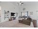 Bright living room with vaulted ceilings, plush carpet, a cozy sectional, and large windows at 16566 Branham Dr, Fishers, IN 46040