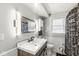 Modern bathroom with a wood vanity, sleek fixtures, and stylish lighting at 1710 Bittersweet Dr, Anderson, IN 46011