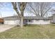 Charming single-story home with a well-maintained lawn and attached two car garage at 1710 Bittersweet Dr, Anderson, IN 46011