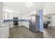 Spacious kitchen featuring white cabinets, stainless steel appliances, and an open layout at 1710 Bittersweet Dr, Anderson, IN 46011