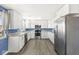 Well-lit kitchen featuring white cabinets and modern stainless steel appliances at 1710 Bittersweet Dr, Anderson, IN 46011