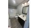 Modern bathroom with a vanity, stylish mirror, and shower-tub combo at 1746 Lambert St, Indianapolis, IN 46221