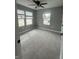 Well-lit bedroom featuring plush carpeting, multiple windows, and a ceiling fan at 1746 Lambert St, Indianapolis, IN 46221