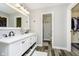 This bathroom features gray walls, wood-style floors, a white double sink vanity, and walk-in closet at 2005 Dakota Dr, Noblesville, IN 46062