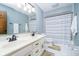 This bathroom features blue walls, white floors, a white double sink vanity, and tub with a shower at 2005 Dakota Dr, Noblesville, IN 46062