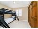 This bedroom features neutral walls, carpeted floors, ceiling fan, and a black bunk bed at 2005 Dakota Dr, Noblesville, IN 46062