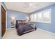 This bedroom features blue walls, carpeted floors, and a large window with white plantation shutters at 2005 Dakota Dr, Noblesville, IN 46062
