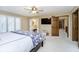 This bedroom features neutral walls, carpeted floors, ceiling fan, and an ensuite bathroom at 2005 Dakota Dr, Noblesville, IN 46062