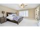 This bedroom features neutral walls, carpeted floors, ceiling fan, and a large window with white plantation shutters at 2005 Dakota Dr, Noblesville, IN 46062