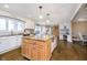 An open kitchen features a large central island with granite countertops and ample storage at 2005 Dakota Dr, Noblesville, IN 46062
