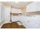 Well-organized laundry room with ample counter space, white cabinets and modern appliances at 2005 Dakota Dr, Noblesville, IN 46062