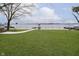 Lush, green lawn leads to a private pier on the serene lake, perfect for outdoor enjoyment at 2005 Dakota Dr, Noblesville, IN 46062