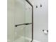 Close-up of shower with glass door and bronze fixtures at 2005 Dakota Dr, Noblesville, IN 46062