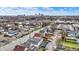 An aerial view showcases a vibrant neighborhood with a cityscape in the distance on a sunny day at 2023 Shelby St, Indianapolis, IN 46203