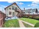 A backyard shows a two story house and garage separated by a small yard with grill and picnic table and gray deck at 2023 Shelby St, Indianapolis, IN 46203