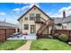 A backyard has a two story house with a small deck and stairs leading to a yard and small patch of grass at 2023 Shelby St, Indianapolis, IN 46203