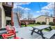 A backyard features a gray picnic table on gray deck and stairs going to an upper level and view of the garage at 2023 Shelby St, Indianapolis, IN 46203