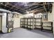 Unfinished basement with utilities, shelving, and circuit breaker box at 2023 Shelby St, Indianapolis, IN 46203