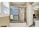 Bathroom features a shower with sliding glass doors and a floral curtain, adjacent to a window for natural light at 2023 Shelby St, Indianapolis, IN 46203