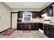 Functional kitchen with dark cabinets, stainless steel sink and plenty of natural light at 2023 Shelby St, Indianapolis, IN 46203
