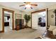 Open-concept living room featuring a TV, plant, and views into the kitchen and home office at 2023 Shelby St, Indianapolis, IN 46203